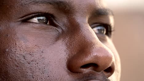 close-up-on-sad-black-african-man-raising-his-head-at-the-sky-praying--macro