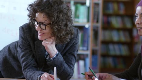 Joyous-Female-Teacher-Interacting-with-Migrant-Students