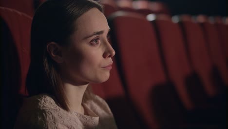 Girl-watching-sad-film-at-movie-theater.-Woman-crying-on-melodrama