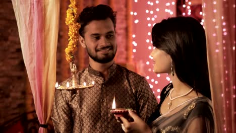 A-happy-husband-and-wife-in-a-house-interior-decorated-with-lights-and-flowers.