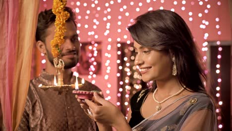 A-newly-married-couple-in-a-house-interior-decorated-with-lights-and-flowers.