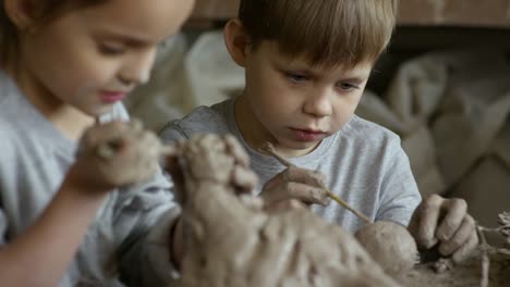 Girl-and-Boy-Sculpting-with-Pottery-Clay