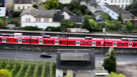 Footage,-a-red-passenger-train-goes-through-the-city.