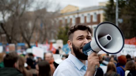 A-person-emotionally-and-cheerfully-speaks-in-megaphone-or-a-speaker-close-up-4k