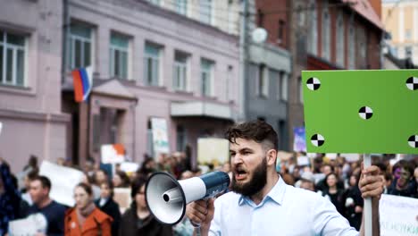 A-rebel-on-a-revolution-shouts-into-a-megaphone-close-up-in-slow-motion.