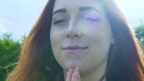 Faithful-woman-prays-in-rain,-red-haired-blessed-girl-smiles-feels-calm-serenity