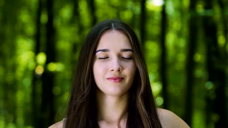Dreaming-lady-with-eyes-closed,-meditating-woman-outdoors-in-forest,-zoom-out