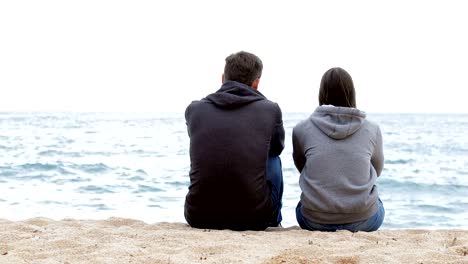 Two-friends-contemplating-ocean-on-the-beach