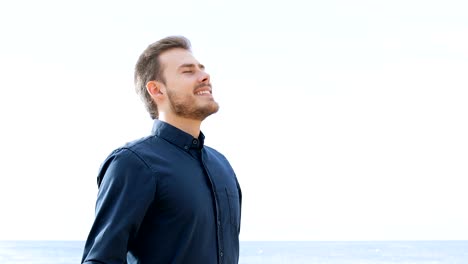 Happy-man-breathing-fresh-air-on-the-beach