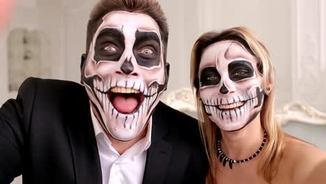 Creepy-couple-with-scary-Halloween-makeup-make-selfies-in-a-studio.