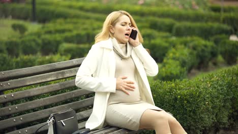 Pregnant-woman-calling-hospital-phone,-suffering-abdominal-pain,-prenatal-care