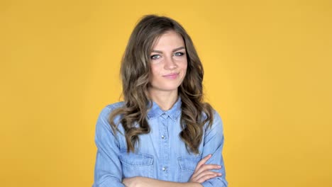 Young-Girl-Shaking-Head-to-Reject-Isolated-on-Yellow-Background