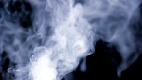 A-lot-of-white-smoke-isolated-on-black-background-slow-motion-up