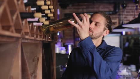 Wine-Restaurant.-Handsome-Man-Choosing-Wine-Bottle-On-Shelf