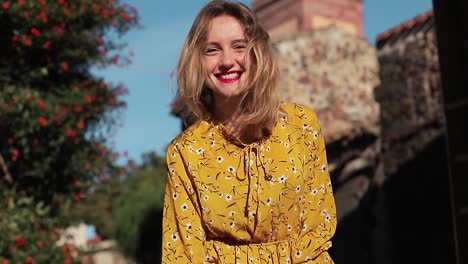 A-beautiful-and-smiling-girl-walks-through-the-streets-of-the-old-Italian-city.