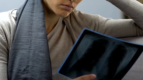 Cancer-patient-looking-at-breast-x-ray-scan,-upset-by-fatal-diagnosis,-closeup