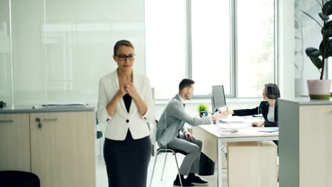 Nervous-young-lady-is-waiting-for-job-interview-standing-near-office-biting-nails-and-feeling-insecure-then-walking-inside-and-talking-to-manager.-Youth-and-stress-concept.