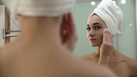 Skin-Care.-Woman-Cleaning-Face-With-Lotion-At-Bathroom