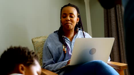 Close-up-of-young-black-father-playing-with-his-son-in-living-of-comfortable-home-4k