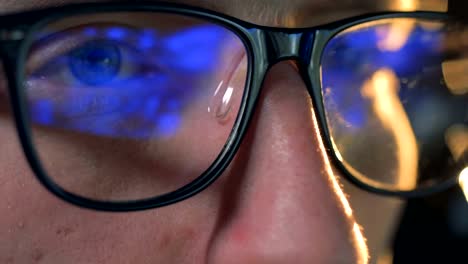 Computer-game-reflected-in-man's-glasses-in-a-close-up