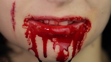 Bloody-mouth-and-teeth-of-girl.-Vampire-Halloween-makeup-with-dripping-blood