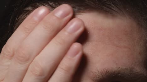 Man-wipes-his-sweating-forehead---Close-up