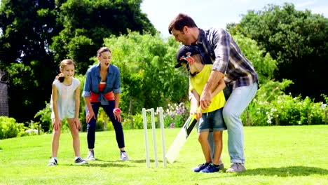 Family-playing-cricket-in-park