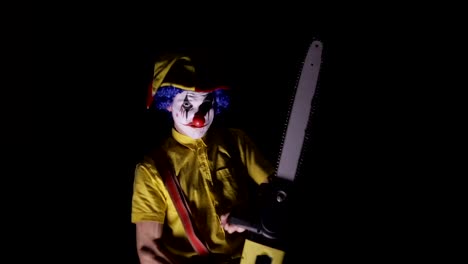 A-clown-comes-out-of-the-dark-with-a-chainsaw.