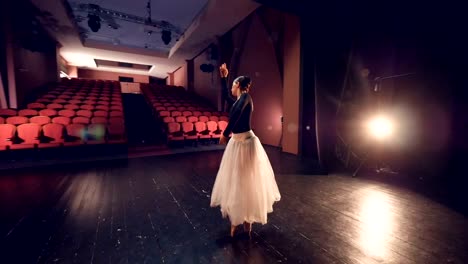 A-ballerina-turns-around-in-the-center-of-an-empty-stage.