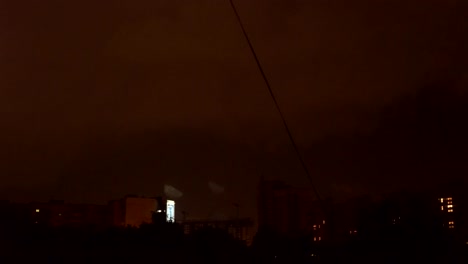 view-from-the-window-to-the-stormy-sky.-night-outside,-outside-the-window-dressed-with-rains-and-lightning-flashed.-seen-from-the-window-high-houses-FullHD