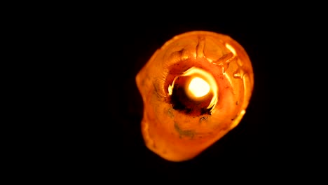 Closeup-abstract-of-a-large,-lone-wax-candle-burning-view-from-the-top-in-slow-motion.