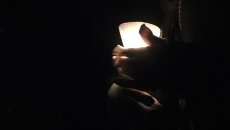 Catholic-penitent-hands-with-a-candle