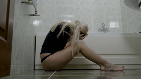 Upset-hot-blonde-teenager-female-wearing-thong-crying-in-the-bathroom-after-breaking-up-with-his-boyfriend