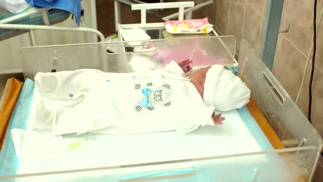 Little-newborn-baby-lying-in-a-cradle-in-hospital.