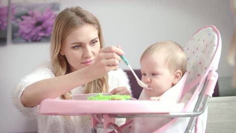 Baby-don't-want-eating-food.-Mother-feeding-child-with-porridge