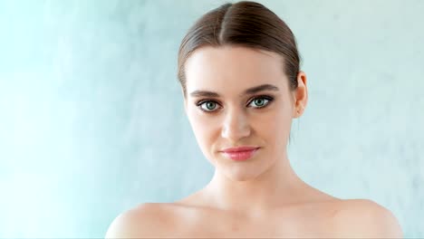 Beautiful-woman-with-clean-skin-and-professional-make-up-posing-in-studio