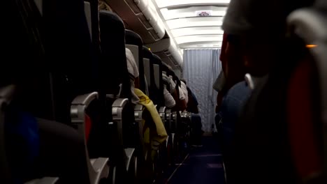 Interior-of-airplane-with-passengers-on-seat-during-flight.-Chairs-on-aisle