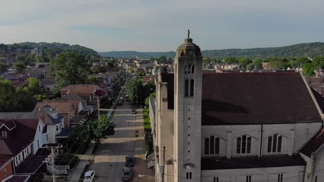 Slow-Lowering-Aerial-Establishing-Shot-of-Small-Town-and-Church