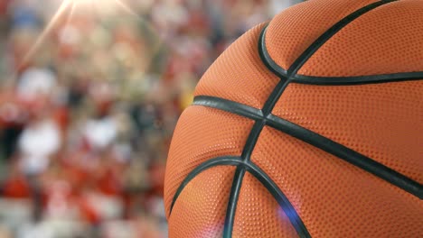 Schönen-Basketball-Ball-drehen-Nahaufnahme-in-Zeitlupe-auf-Stadion-Hintergrund-mit-Flare.-Geloopt-Basketball-3D-Animation-Ball-zu-verwandeln.-4k-UHD-3840-x-2160.