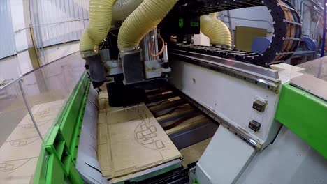 Automatische-Holzbearbeitungsmaschine-schneidet-Details-auf-einer-Holzplatte,-Routing-Edgebanding-nisten-Holzbearbeitungsmaschine,-industrielle-Interieur,-moderne-Holzbearbeitung-Maschine,-close-up,-timelapse