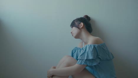 Sad-woman-sitting-alone-in-a-empty-room