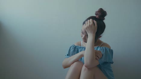 Sad-woman-sitting-alone-in-a-empty-room