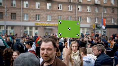 European-people-at-demonstration.-Man-with-a-banner-screaming-into-a-mouthpiece.