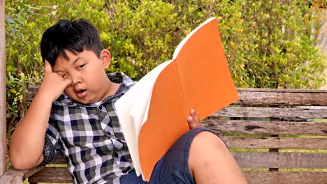 Cute-asian-children-is-bored-and-tired-with-reading-a-book.-education-concept