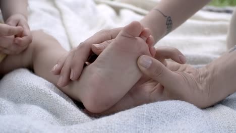 Mother-Touching-Foot-of-Baby