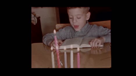 1958-Young-jewish-boy-reads-book-at-Hanukkah