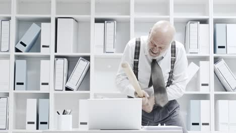 Stressed-businessman-smashing-his-laptop-with-a-bat