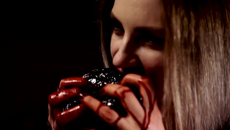 close-up-of-a-light-girl-biting-a-bloody-piece-of-meat.-the-girl's-face-and-hands-are-stained-with-blood.