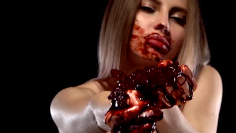 young-fair-skinned-girl,-both-hands-tearing-bloody-heart.-Her-face-is-covered-in-blood.