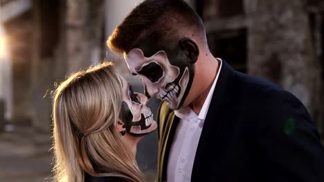 Couple-with-skull-makeup-on-the-background-of-an-abandoned-building.-Halloween.